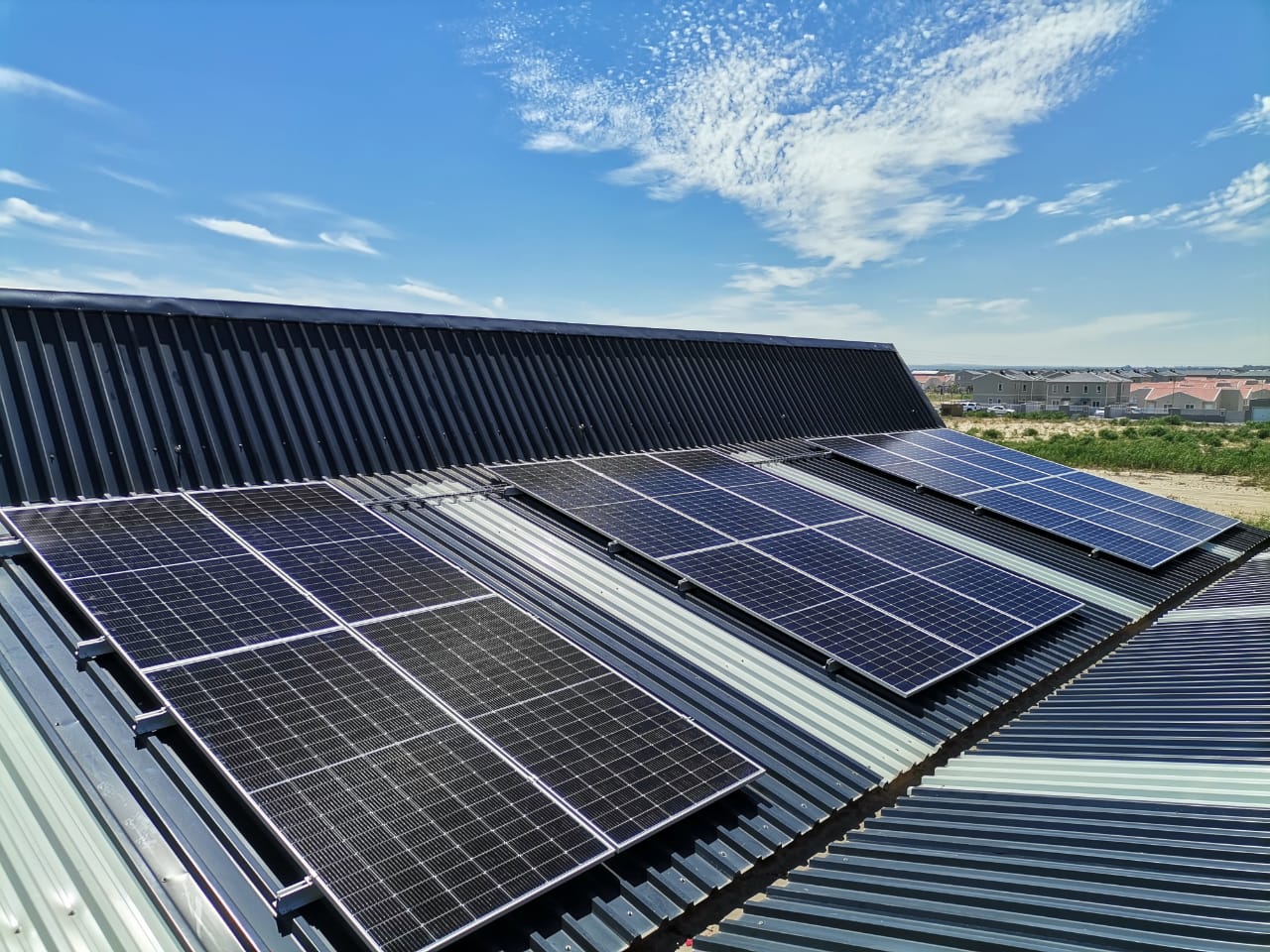 Hybrid rooftop solar PV installation by Winelands Solar — black-frame panels mounted on a residential roof in the Western Cape
